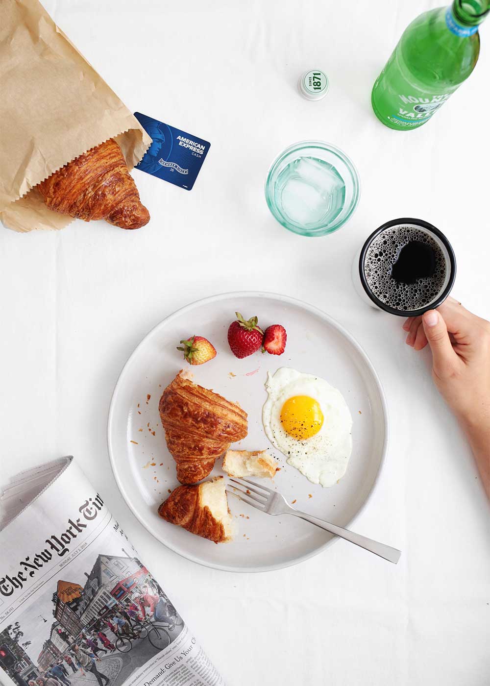 Breakfast scene with croissant and egg