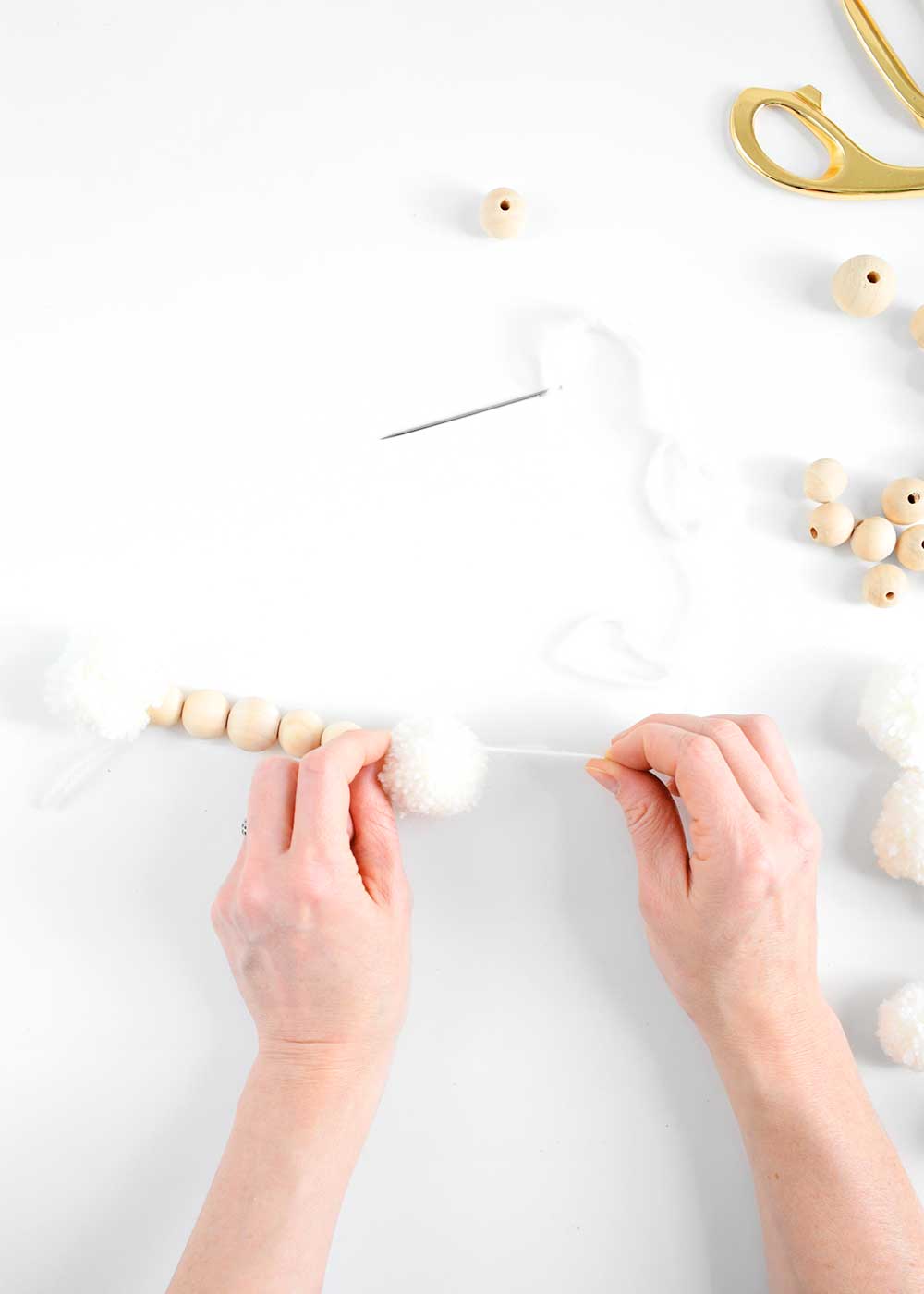 wooden bead garland with wool balls