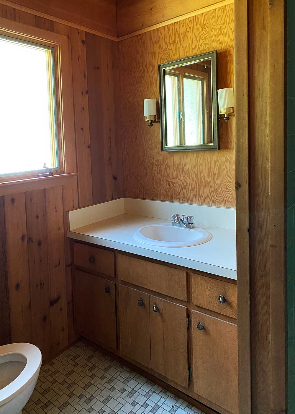 The Minne Stuga Cabin Bathroom before vanity from The Faux Martha